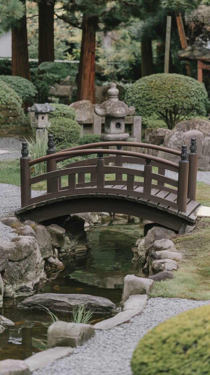 A wooden arched bridge over a small stream in a Japanese garden